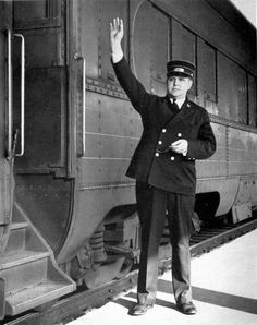 a man standing next to a train on the cover of a magazine with an image of a person waving