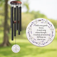 a wind chime hanging from a tree with a poem written on the front and back