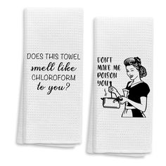 two white towels with black writing on them and one has an image of a woman holding a jug