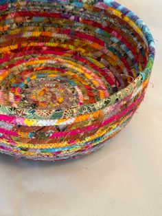 a multicolored bowl sitting on top of a white table