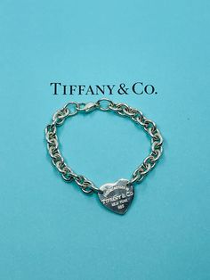 Authentic vintage sterling silver  Tiffany&Co heart tag bracelet. Inspired by the iconic key ring first introduced in 1969, the Return  toTiffany collection is a classic  reinvented .A truly  elegant design , this bracelet embodies the collection 's timeless  and celebrated  aesthetic . Condition: Pre-owned in very good condition. This item does not come with TIFFANY&Co box and pouch. Tiffany And Co Bracelet Sterling Silver, Sterling Silver Tiffany, Tiffney And Co Jewelry, Classic Silver Heart Bracelet, Classic Sterling Silver Heart Bracelet For Valentine's Day, Classic Gold Heart Bracelet, Classic Jewelry For Valentine's Day, Classic Heart Jewelry For Collectibles, Classic Engraved Bracelets For Valentine's Day