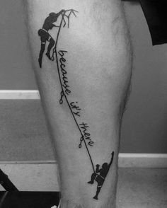 a man with a tattoo on his leg that has an arrow and two people climbing up it