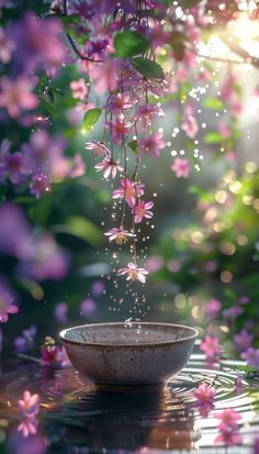 a bowl that is sitting in the water with some flowers hanging from it's side