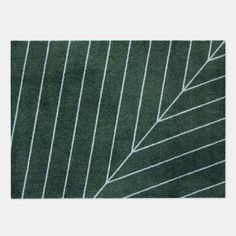 a green rug with white lines on it