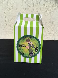 a green and white striped box with a cartoon character on it