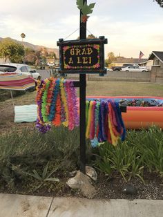 a sign that is on the side of a pole with some decorations hanging from it