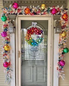 the front door is decorated with christmas ornaments