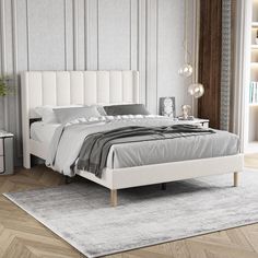 a white bed sitting on top of a wooden floor next to a wall mounted book shelf