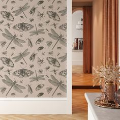 the wall paper has dragonflies and other insects on it in an elegant room with wood floors