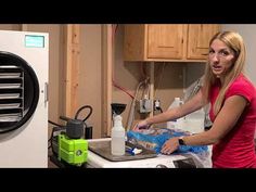 a woman standing in front of a stove top oven