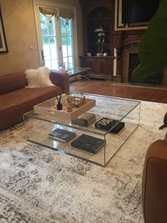 a living room filled with furniture and a fire place in the middle of the room