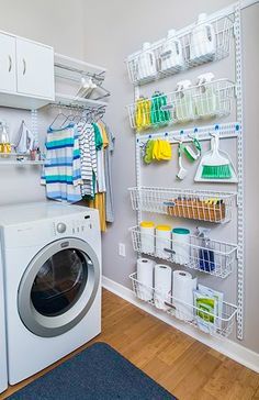 a washer and dryer in a laundry room with white shelving on the wall