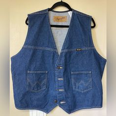 This Wrangler Vest Is In Perfect Condition Without Tags. Beautiful Dark Blue And Can Be Styled So Many Ways. Comes From A Pet Free And Smoke Free Home Western Denim Outerwear With Pockets, Western Denim Vest For Fall, Western Style Medium Wash Cotton Outerwear, Western-style Medium Wash Cotton Outerwear, Cotton Denim Jacket With Pockets For Rodeo, Western Style Cotton Outerwear In Medium Wash, Vintage Cotton Denim Jacket For Rodeo, Vintage Medium Wash Denim Jacket For Rodeo, Tan Denim Jacket