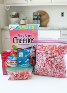 two bags of cereal sitting on top of a counter next to a box of cereal