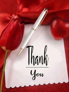 a thank you note with a pen on it and a red rose next to it