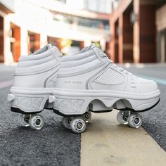 a pair of white roller skates sitting on the street