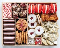 a box filled with lots of different types of cookies and pastries on top of each other