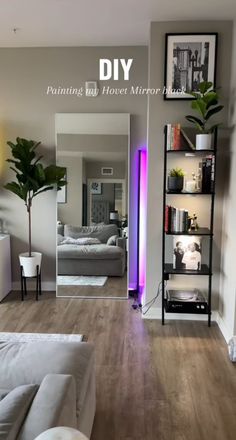 a living room filled with furniture and a large mirror on the wall next to it