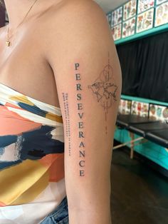 a woman with a tattoo on her arm that says perseverance