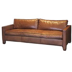 a brown leather couch sitting on top of a white floor