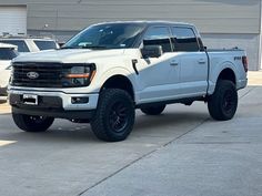 a white truck parked in front of a building