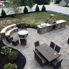 an outdoor patio with seating and fire pit