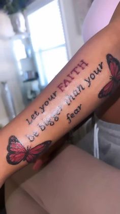 a woman with a tattoo on her arm that says, let your faith be what you are