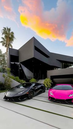 two pink and black lambs parked in front of a large modern house with palm trees