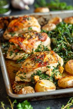 a pan filled with chicken, potatoes and greens