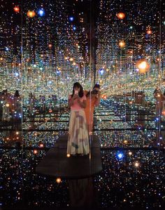 two people standing on a platform in front of an array of lights