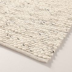 an area rug with white and black designs on it