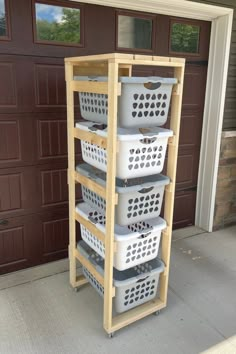 three white baskets stacked on top of each other in front of a garage door