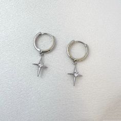 Elevate your streetwear game with our Star Dangle Drop Earrings! Exuding punk and hip hop vibes, these earrings are perfect for men and women alike. Stand out from the crowd and add a touch of edgy style to your look. Perfect for expressing your unique personality. Earrings length 1.0 inch width 0.3 inch. Streetwear Dangle Pierced Earrings, Streetwear Dangle Earrings, Trendy Metal Earrings For Streetwear, Trendy Metal Hoop Earrings For Streetwear, Single Metal Earring For Streetwear, Punk Dangle Earrings For Streetwear, Silver Trendy Hoop Earrings For Streetwear, Metal Hoop Earrings For Streetwear, Punk Silver Hoop Earrings For Streetwear