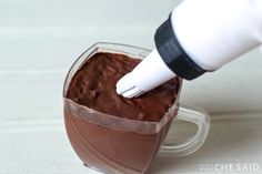 a person is dipping chocolate into a blender