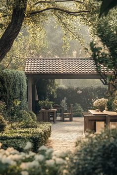 an outdoor dining area in the middle of a garden with tables and chairs around it