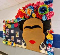 a bulletin board with flowers on it and a woman's face in the center