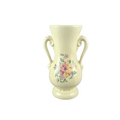 a white vase with flowers painted on the front and sides, sitting against a white background