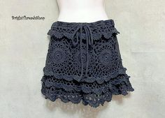 This black crochet lace summer  skirt is crocheted from viscose-acrylic  threads. Several rows of frills on the skirt give a special charm that looks very original. This mini skirt  has a lace that holds it on the waist or hips. You can order this boho style skirt  with or without lining.   It is  a skirt for the city or a beautiful cover-up for the beach.  The picture shows the size XS. The skirt is made to order. Available in four US sizes: XXS, XS, S, M, L Size: XXS hips - 32in / 80cm XS hips Crochet Summer Skirt, Black Boho Skirt, Crochet Lace Skirt, Lace Skirt Black, Boho Style Skirts, Hippy Festival, Festival Skirt, Skirt Crochet, Skirt Beach