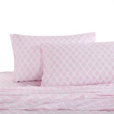 a bed with pink sheets and pillows on top of it, against a white background