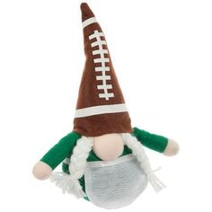 Dimensions: 9.5" H x 8.25" W x 3.25" D Material: Fabric Color: Brown, White & Green Quantity: 1 Add some sporty spirit to your holiday displays with this Football Gnome With Braids. This little gnome wears a posable brown hat embellished with football markings. They have a green shirt with a mesh apron and boast long white braids on either side of their round nose. With a weighted bottom, this sporty friend will stay in place on your mantel or coffee table! White Braids, Football Gnome, Thanksgiving Tabletop Decor, Round Nose, Brown Hat, Holiday Messages, Harvest Thanksgiving, White Apron, Fall Table Decor