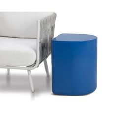 a white chair next to a blue stool