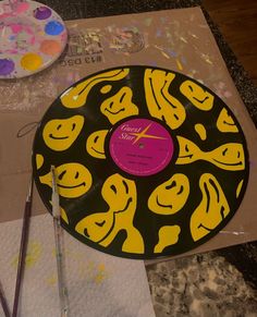 a record sitting on top of a table covered in paint