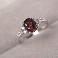 * The delicate ring displays Garnet as main stone. The cluster side stones make the ring similar to the blooming flower . For who wearing this special & delicate ring, will shine like a goddess. ◆ Production Description: Main stone Type: Garnet Main Stone Shape: Oval Cut Main Stone Size: 6*8mm(1.73ct) Side stone: CZ Metal: 925 Sterling silver - Other options available in the drop down menu ◆ Customization: √Free for Add Engraving √Other Metal Type Available √Other Gemstones & Shapes Avai Delicate Oval Crystal Promise Ring, Elegant Garnet Cluster Ring With Birthstone, Elegant Garnet Birthstone Cluster Ring, Delicate Oval Gemstone Birthstone Ring, Delicate Oval Birthstone Ring, Elegant Garnet Cluster Ring For Wedding, Exquisite Oval Crystal Ring For Anniversary, Elegant Garnet Crystal Ring With Gemstone, Elegant Marquise Crystal Ring With Gemstone