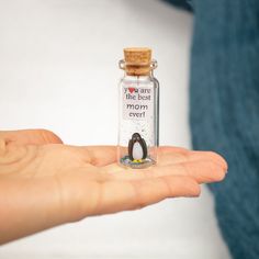 a tiny penguin in a bottle with a message inside