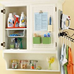 an organized kitchen cabinet with cleaning products on it