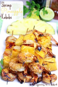 shrimp and pineapple kabobs on a white plate