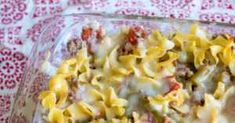 a glass casserole dish filled with pasta and meat