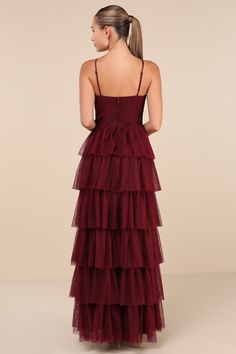 Treat any event like your own personal fashion show when you're wearing a show-stopping look like the Lulus Rule the Runway Burgundy Tulle Surplice Tiered Maxi Dress! This stunning dress is composed of sheer tulle-like mesh (atop a stretch knit lining) that shapes a pleated, sleeveless bodice, a flattering surplice neckline, and adjustable spaghetti straps. The high, banded waist tops an A-line maxi skirt, adorned with fluffy tiers of tulle that are sure to make you look ""tulle-y"" mesmerizing as you dance the night away! Hidden back zipper/clasp. Fit: This garment fits true to size. Length: Floor length. Size medium measures 61.5" from adjustable straps to hem. Bust: Great for any cup size. Waist: Fitted - very fitted at natural waist. Hip: Not Fitted - fuller skirt allows room for hips. Tiered Tulle Dress, Surplice Neckline, Tiered Maxi Dress, Cup Size, Tulle Dress, Stunning Dresses, Full Skirt, Floor Length, Maxi Skirt