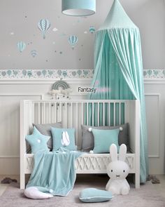 a baby's room is decorated in blue and gray colors with hot air balloons on the wall