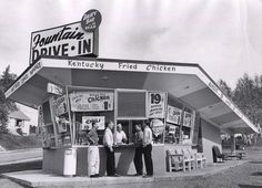 black and white photograph of three men standing in front of a drive - in restaurant